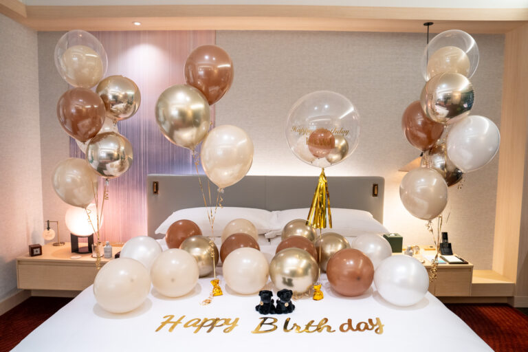Gold-themed birthday surprise decorations for a Fairmont Tokyo bedroom