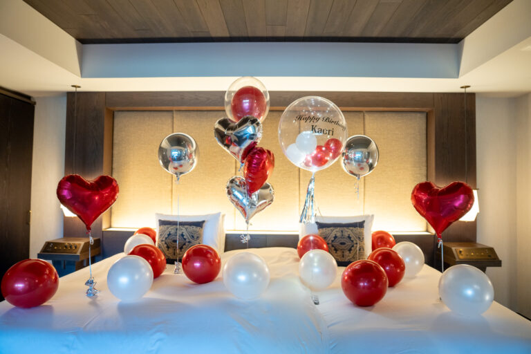 Birthday surprise decoration at ふふ 奈良, red, white, and silver balloon decorations
