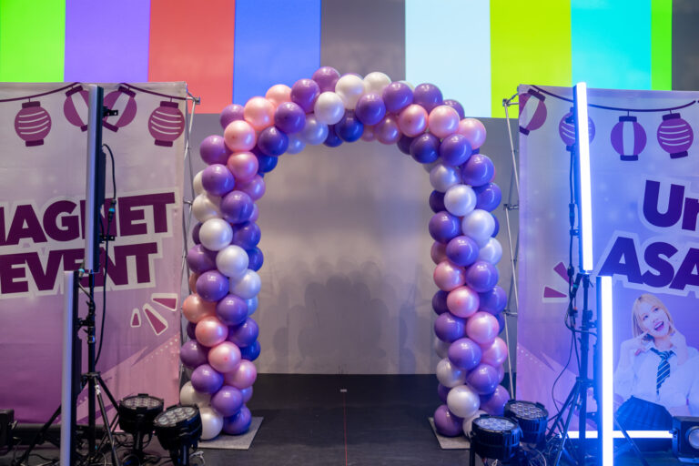 Purple, pink, and white balloon arch decoration for a corporate party photo spot at Hulic Hall Tokyo