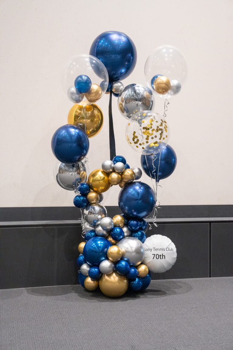 Celebrating the 70th anniversary party at Sony City Shinagawa with dark blue & gold balloon decorations
