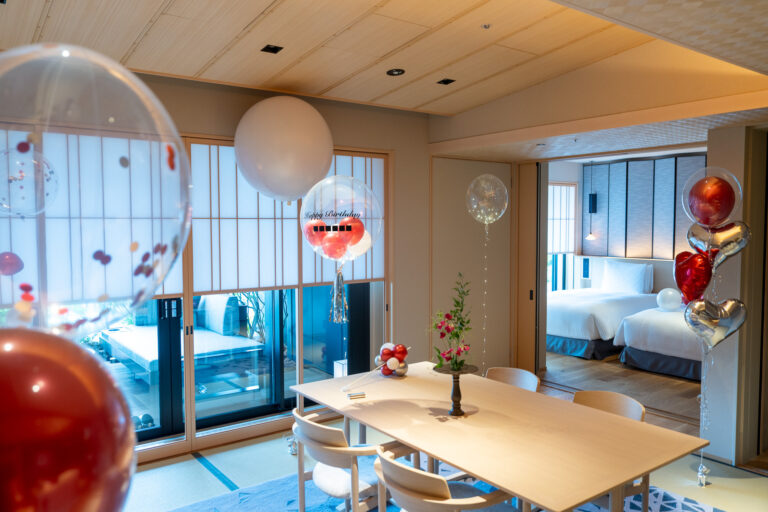 Birthday surprise decoration at ふふ東京銀座: Red, white & gold balloon decoration