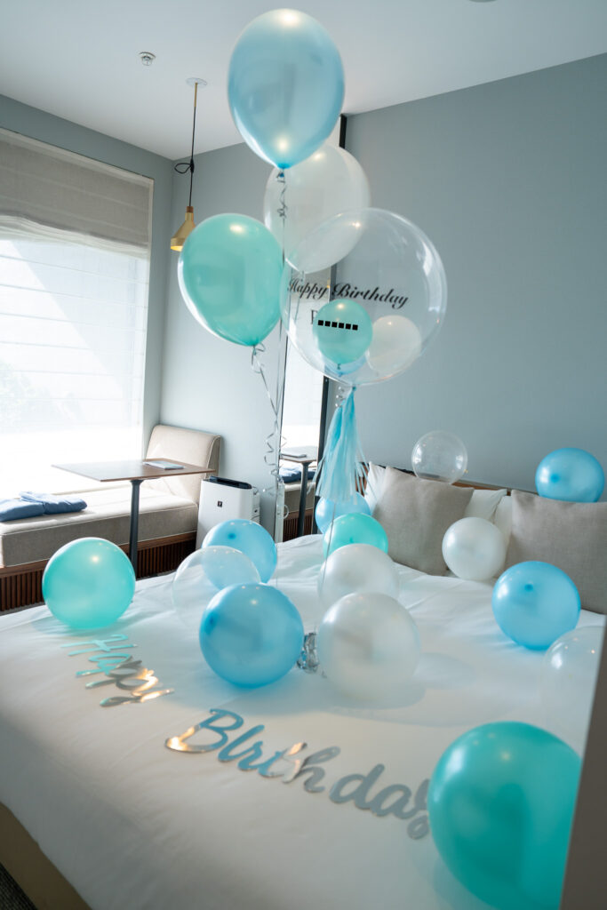 Turquoise blue birthday surprise decorations in a HAMACHO HOTEL guest room
