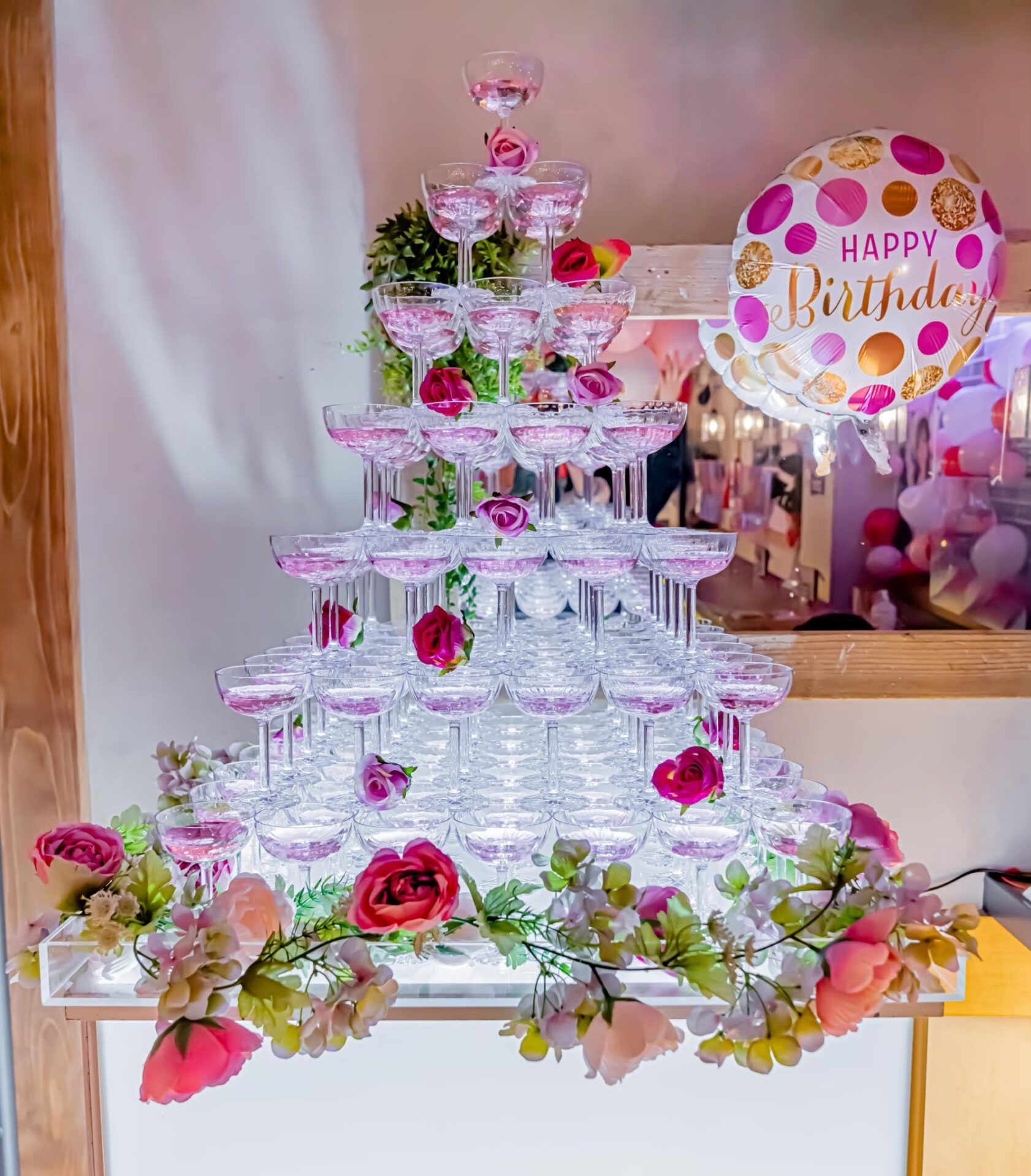Champagne tower prettily decorated in soft pink